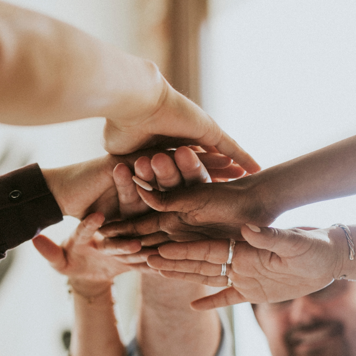 Several people put their hands together